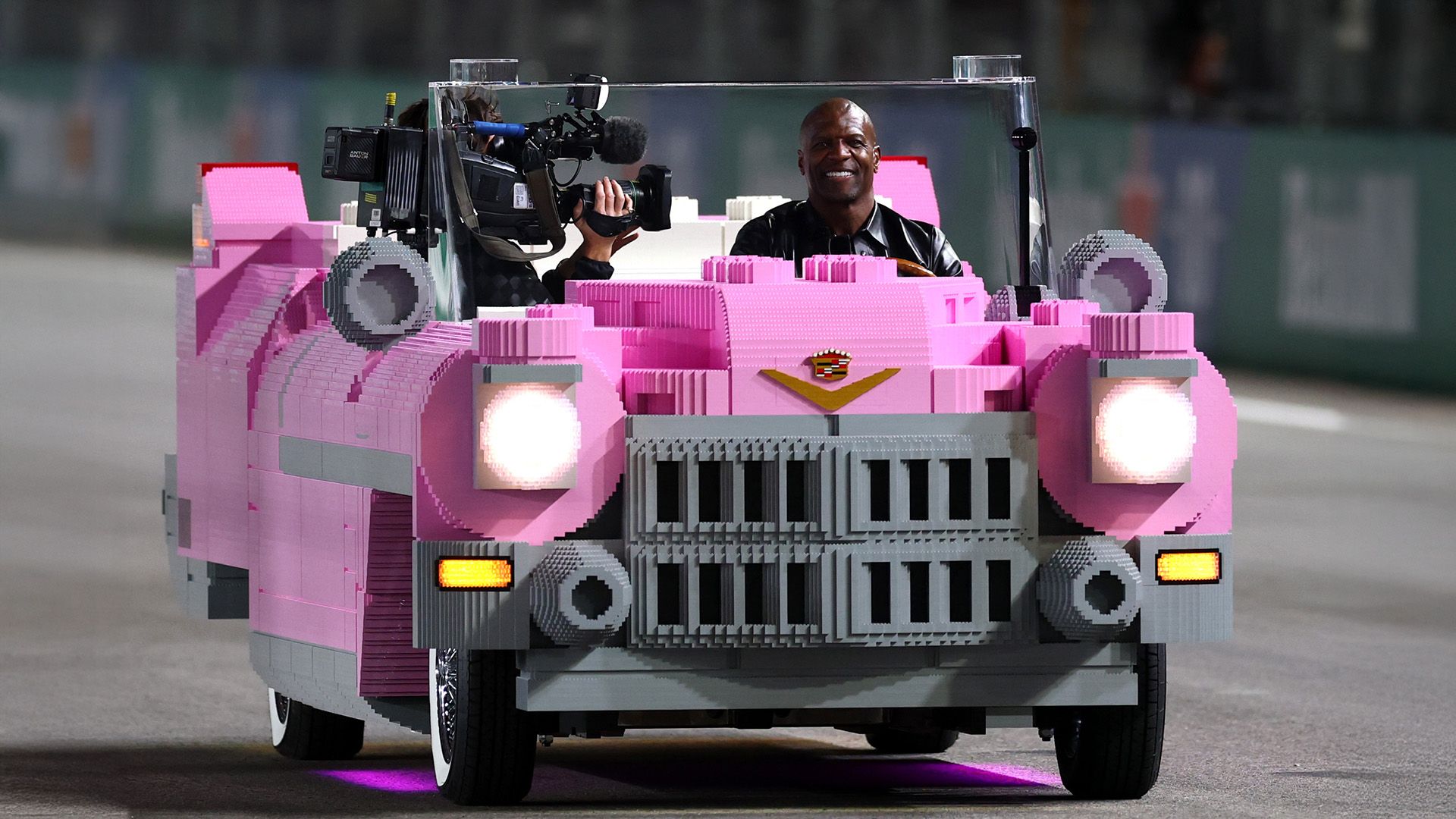 Terry Crews driving a full-size Lego 1950s pink Cadillac is the